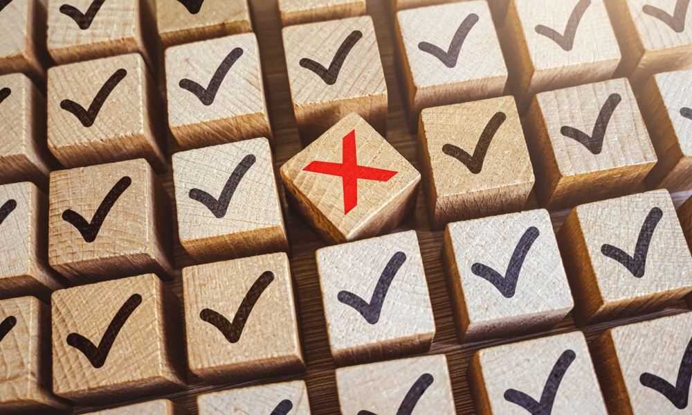 Checkmark icons with one marked with a red cross, symbolizing task completion and rejection, representing choosing the right qualifications for becoming a contractor.