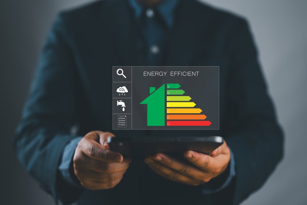 Energy-efficient home with digital energy rating display on tablet, promoting sustainable building practices.
