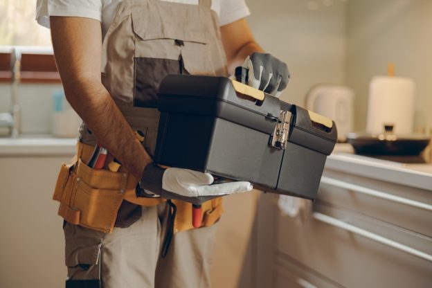 Toolbox for a contractor with a construction worker holding a toolbox, showing a skilled tradesperson ready for home repairs or improvement work.