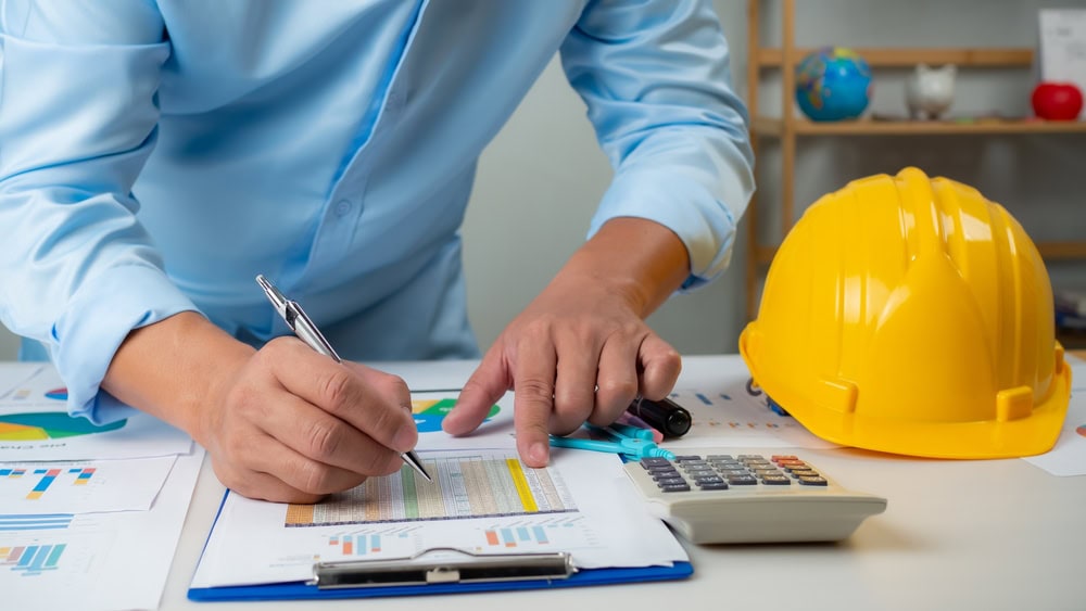 Construction planning with safety gear and blueprints for prospective contractors.