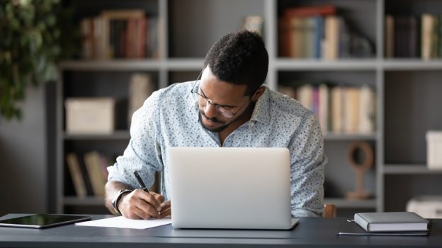 Licensed contractor studying and preparing certification at home for construction licensing exams.